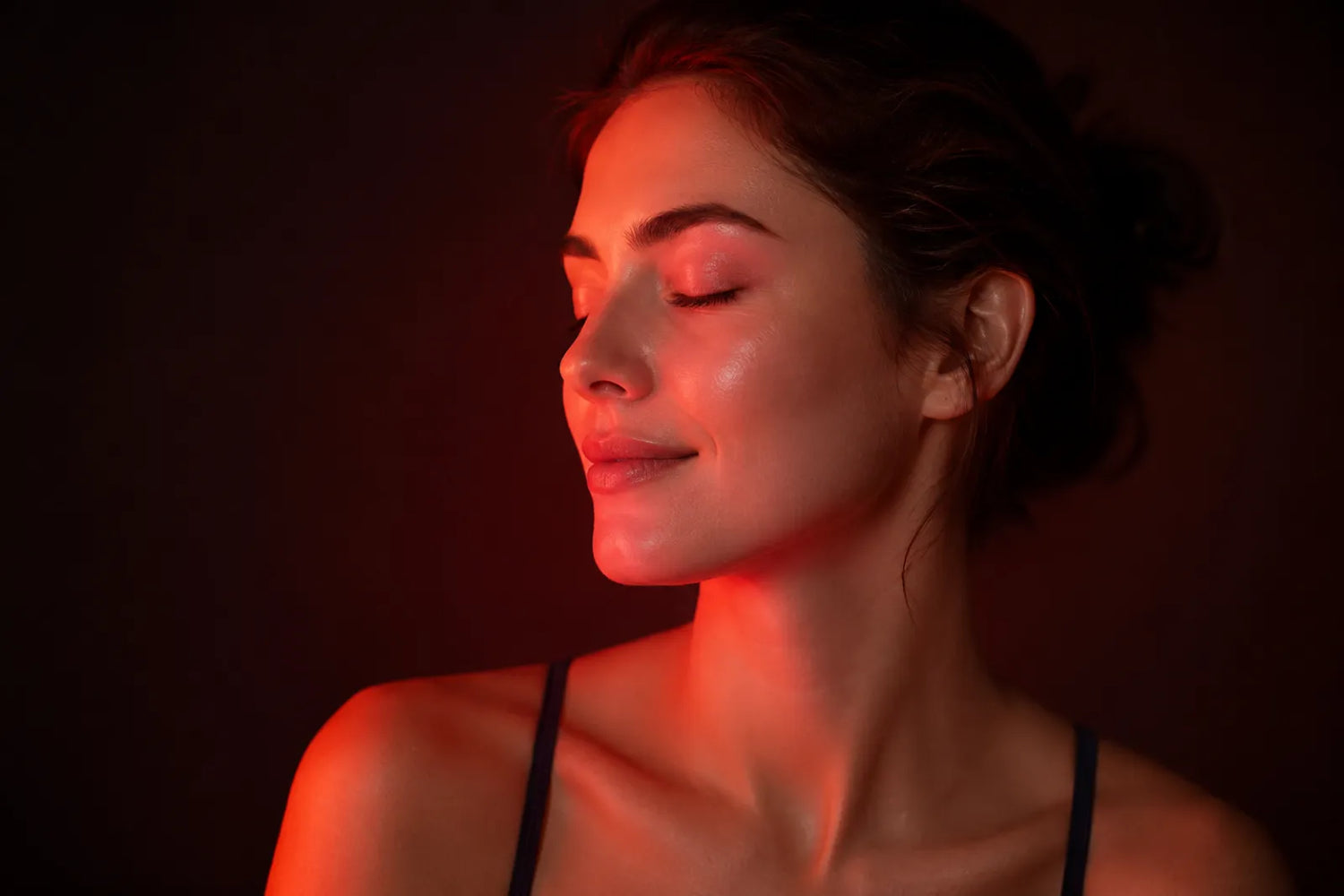 Glowing healthy skin under soft red light, red light therapy for beginners