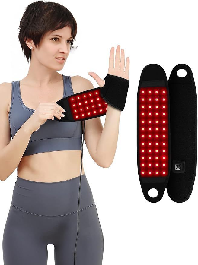 Woman wearing a LED therapy device on her arm with two additional devices beside her.