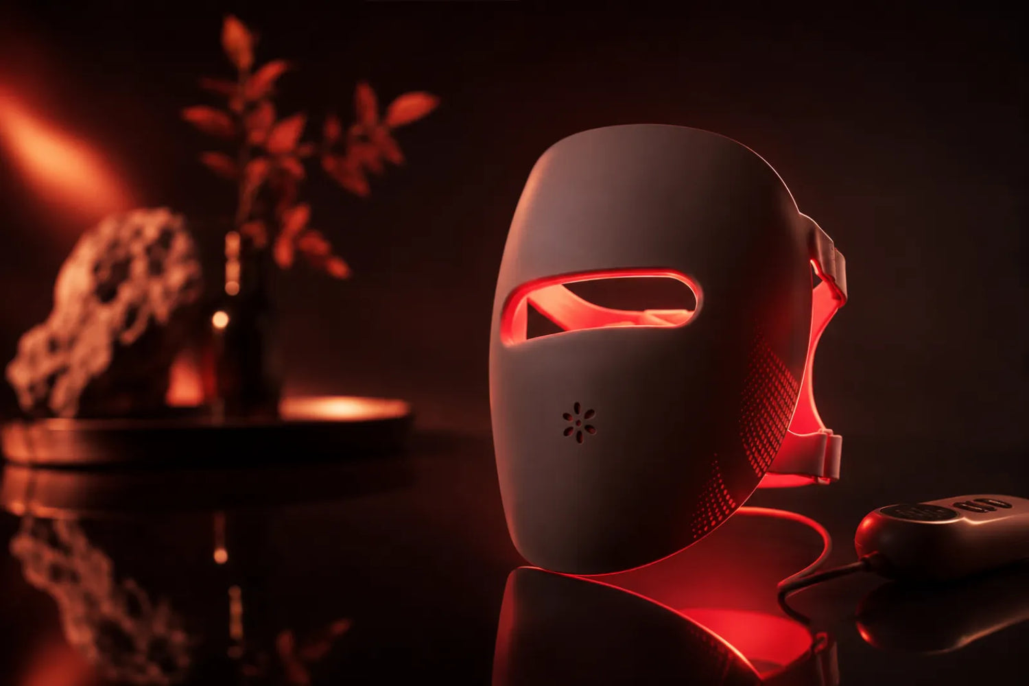 Lumovex red light therapy LED face mask glowing on a dark surface