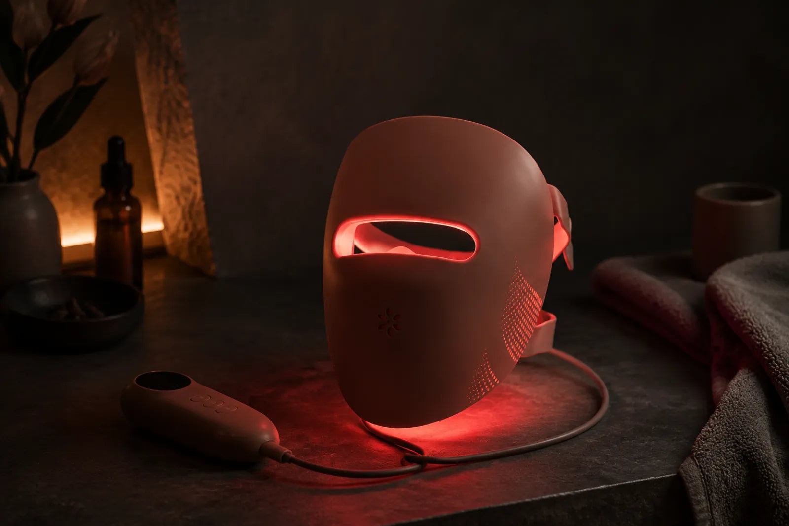 Lumovex red light therapy LED face mask glowing on a dark surface