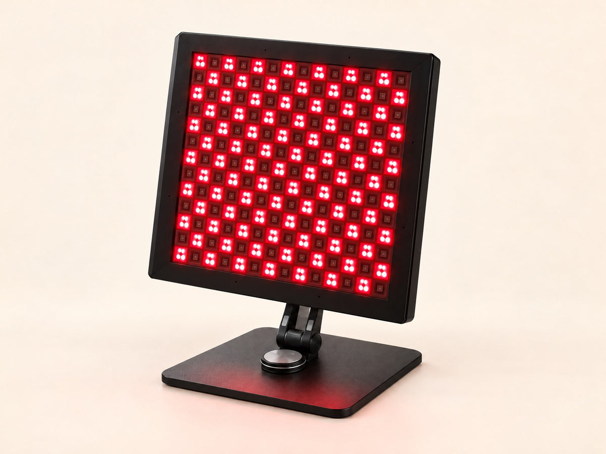Lumovex Pro Panel 540 red light therapy panel switched on, on its adjustable stand, on a plain cream background